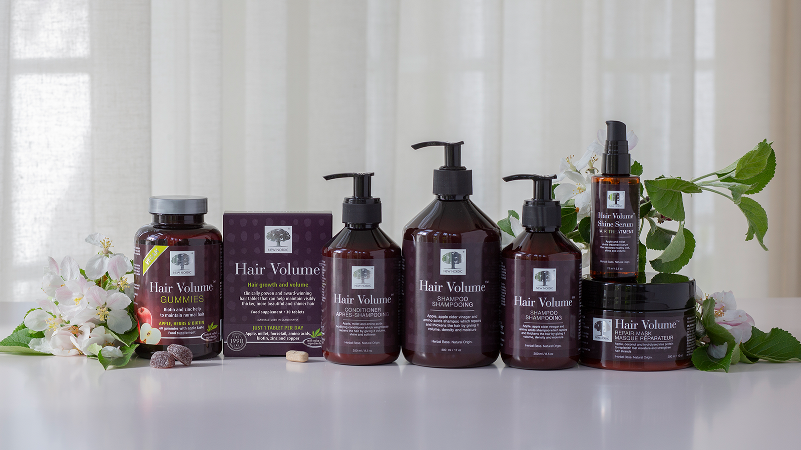 New Nordic Hair Volume™ serien med gummies, tabletter, shampoo, conditioner, shine serum og repair mask til pleje af hår og hovedbund.